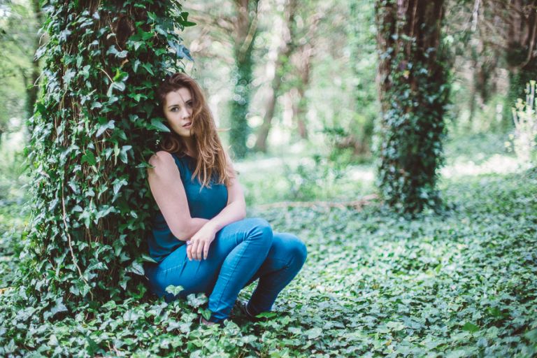 laura portrait photography on location in woods by tree